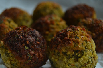 Falafel on white paper. vegan food on a white background. fresh vegan tasty falafel with spices, falafel baked in the oven. chickpeas balls. a source of protein for vegans. 
