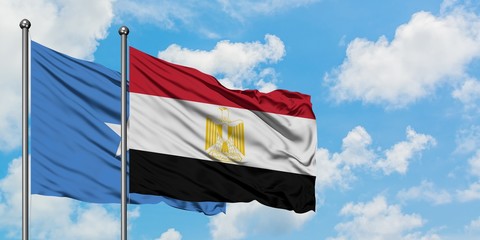 Somalia and Egypt flag waving in the wind against white cloudy blue sky together. Diplomacy concept, international relations.