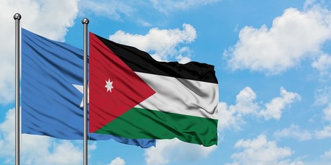 Naklejka na ściany i meble Somalia and Jordan flag waving in the wind against white cloudy blue sky together. Diplomacy concept, international relations.