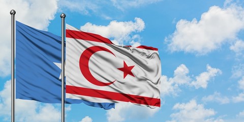 Somalia and Northern Cyprus flag waving in the wind against white cloudy blue sky together. Diplomacy concept, international relations.