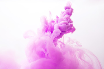 Abstract flowing liquid or purple ink in water on a white background.