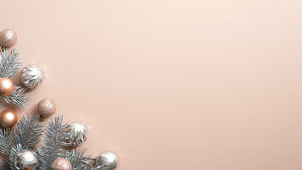 Christmas tree branch with balls on copper background. Xmas frame, luxury New Year banner mockup...