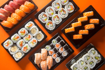 assorted sushi on orange background