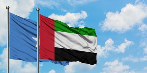 Somalia and United Arab Emirates flag waving in the wind against white cloudy blue sky together. Diplomacy concept, international relations.