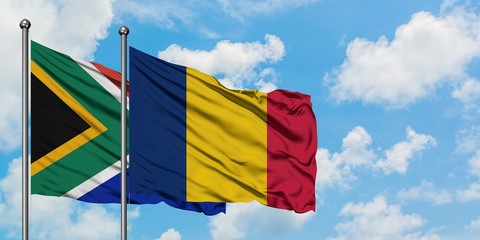South Africa and Chad flag waving in the wind against white cloudy blue sky together. Diplomacy concept, international relations.