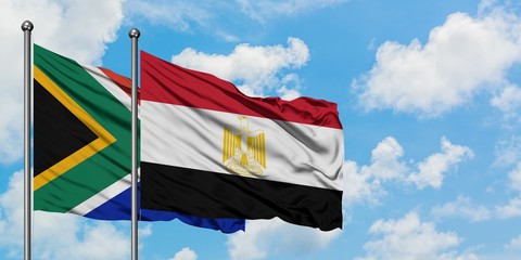 South Africa and Egypt flag waving in the wind against white cloudy blue sky together. Diplomacy concept, international relations.