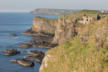Northern Ireland coastline with Dunluce Castle in the foreground.