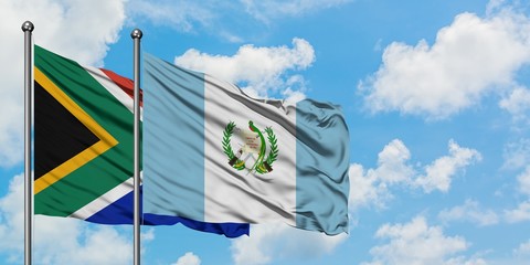 South Africa and Guatemala flag waving in the wind against white cloudy blue sky together. Diplomacy concept, international relations.