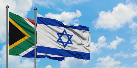 South Africa and Israel flag waving in the wind against white cloudy blue sky together. Diplomacy concept, international relations.