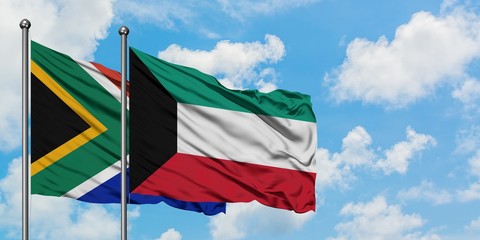 South Africa and Kuwait flag waving in the wind against white cloudy blue sky together. Diplomacy concept, international relations.