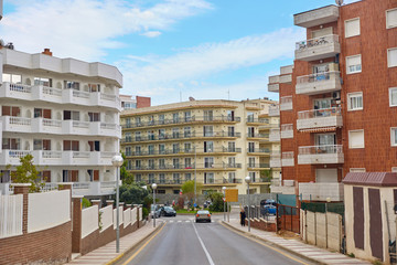 Road for cars between high-rise buildings in Calella, Spain.