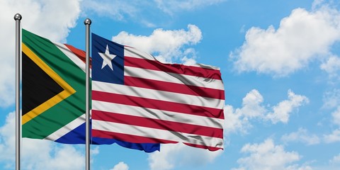 South Africa and Liberia flag waving in the wind against white cloudy blue sky together. Diplomacy concept, international relations.