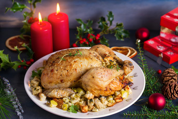Roasted chicken with apple and bread stuffing. Christmas decorations. Dish for Christmas Eve. New Year food menu.