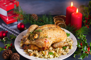 Roasted chicken with apple and bread stuffing. Christmas decorations. Dish for Christmas Eve. New Year food menu.