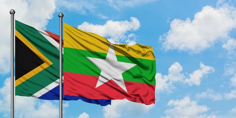 South Africa and Myanmar flag waving in the wind against white cloudy blue sky together. Diplomacy concept, international relations.