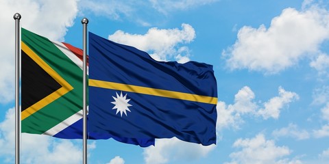 South Africa and Nauru flag waving in the wind against white cloudy blue sky together. Diplomacy concept, international relations.