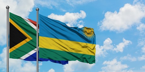 South Africa and Rwanda flag waving in the wind against white cloudy blue sky together. Diplomacy concept, international relations.