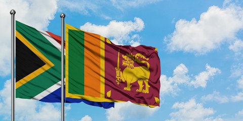 South Africa and Sri Lanka flag waving in the wind against white cloudy blue sky together. Diplomacy concept, international relations.