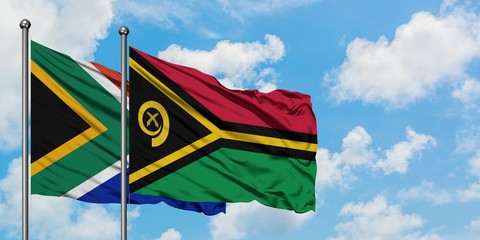 South Africa and Vanuatu flag waving in the wind against white cloudy blue sky together. Diplomacy concept, international relations.