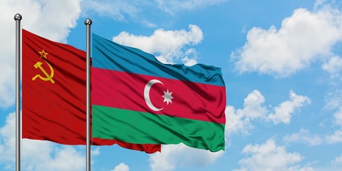 Soviet Union and Azerbaijan flag waving in the wind against white cloudy blue sky together. Diplomacy concept, international relations.