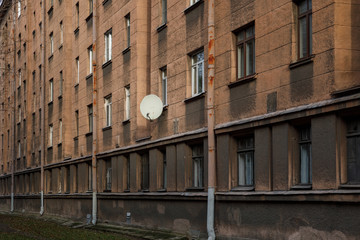 Fototapeta na wymiar satellite dish on the wall of a residential building