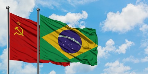 Soviet Union and Brazil flag waving in the wind against white cloudy blue sky together. Diplomacy concept, international relations.