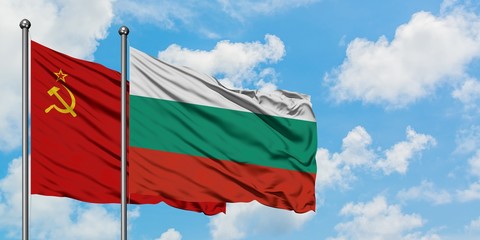 Soviet Union and Bulgaria flag waving in the wind against white cloudy blue sky together. Diplomacy concept, international relations.