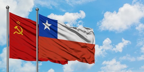 Soviet Union and Chile flag waving in the wind against white cloudy blue sky together. Diplomacy concept, international relations.