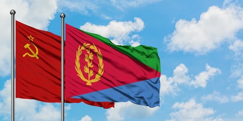 Soviet Union and Eritrea flag waving in the wind against white cloudy blue sky together. Diplomacy concept, international relations.