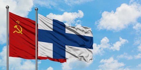Soviet Union and Finland flag waving in the wind against white cloudy blue sky together. Diplomacy concept, international relations.