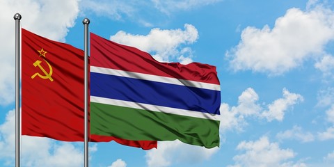 Soviet Union and Gambia flag waving in the wind against white cloudy blue sky together. Diplomacy concept, international relations.