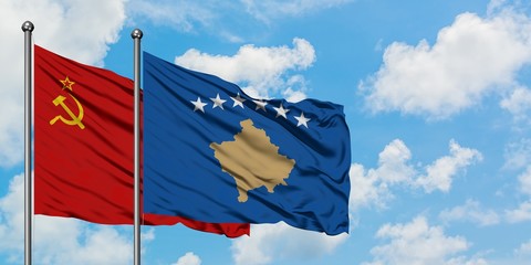 Soviet Union and Kosovo flag waving in the wind against white cloudy blue sky together. Diplomacy concept, international relations.