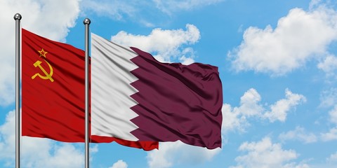 Soviet Union and Qatar flag waving in the wind against white cloudy blue sky together. Diplomacy concept, international relations.