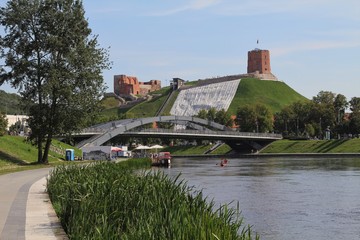 Vilnius old town. Medieval architecture. City streets. Buildings, facades and roofs. Green hills...