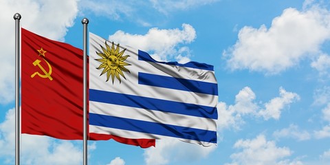 Soviet Union and Uruguay flag waving in the wind against white cloudy blue sky together. Diplomacy concept, international relations.