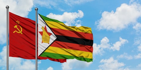 Soviet Union and Zimbabwe flag waving in the wind against white cloudy blue sky together. Diplomacy concept, international relations.