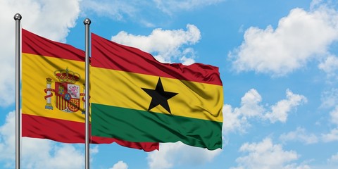 Spain and Ghana flag waving in the wind against white cloudy blue sky together. Diplomacy concept, international relations.