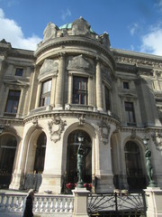 Lamppost caryatids outside the Paris Opera House on a sunny day  
