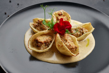 Italian pasta Conkiglioni with meat and mushrooms