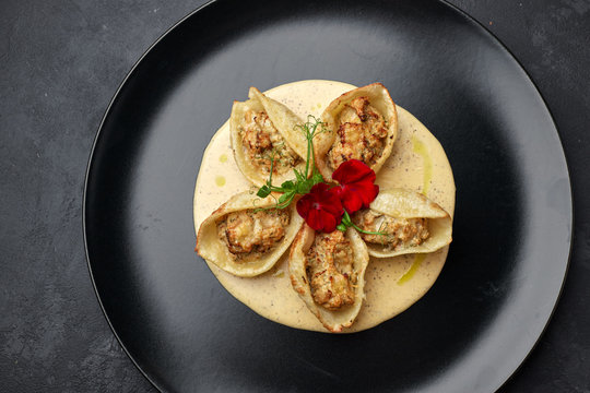 Italian pasta Conkiglioni with meat and mushrooms