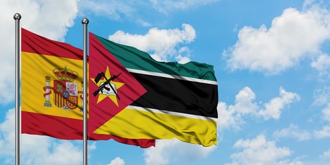 Spain and Mozambique flag waving in the wind against white cloudy blue sky together. Diplomacy concept, international relations.
