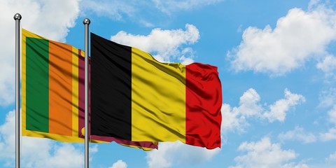 Sri Lanka and Belgium flag waving in the wind against white cloudy blue sky together. Diplomacy concept, international relations.