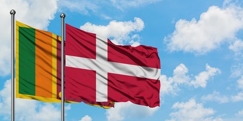 Sri Lanka and Denmark flag waving in the wind against white cloudy blue sky together. Diplomacy concept, international relations.