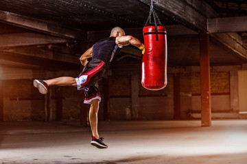 Athletic Men Hitting Punching, Boxing Bag.  Boxing, MMA Men Workout with Boxing Bag