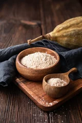 Rolgordijnen Organic baobab powder in a wooden bowl, healthy sport nutrition rich in vitamins and minerals © Marcus Z-pics