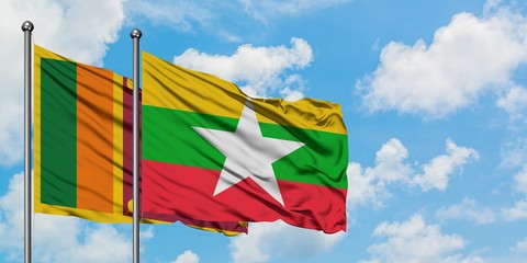 Sri Lanka and Myanmar flag waving in the wind against white cloudy blue sky together. Diplomacy concept, international relations.