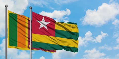 Sri Lanka and Togo flag waving in the wind against white cloudy blue sky together. Diplomacy concept, international relations.