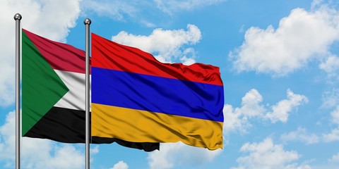 Sudan and Armenia flag waving in the wind against white cloudy blue sky together. Diplomacy concept, international relations.