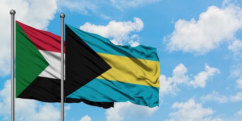 Sudan and Bahamas flag waving in the wind against white cloudy blue sky together. Diplomacy concept, international relations.