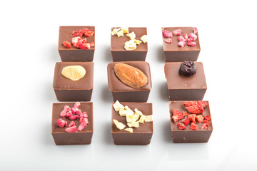 A pieces of homemade chocolate isolated on white background. side view.